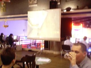 Fitchy drinks beer while X-Files watches a screen showing the match being played.
