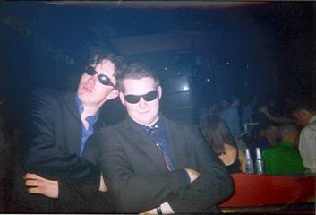 DJ Ess and Roady Nase pose in front of a packed house.