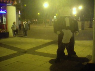 He he. The bouncer takes off his coat and beats up the huge inflatible man. Funny.